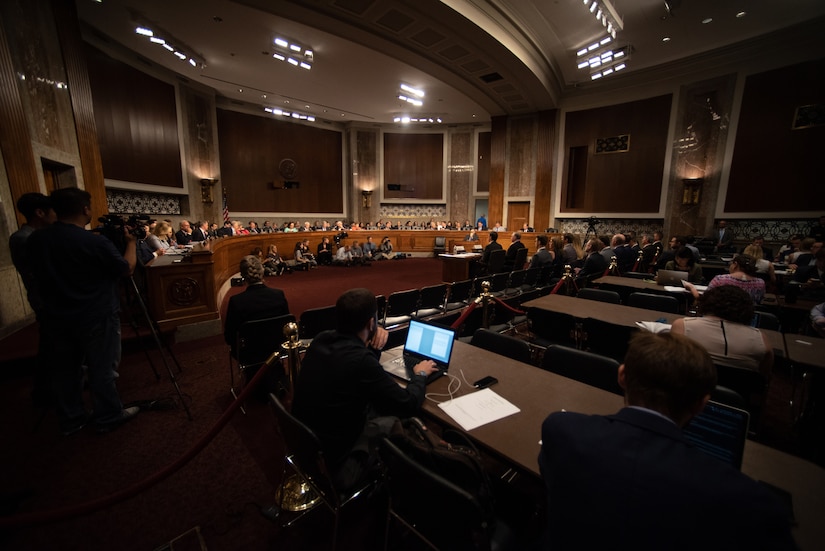Wide-angle view of Senate committee hearing room.
