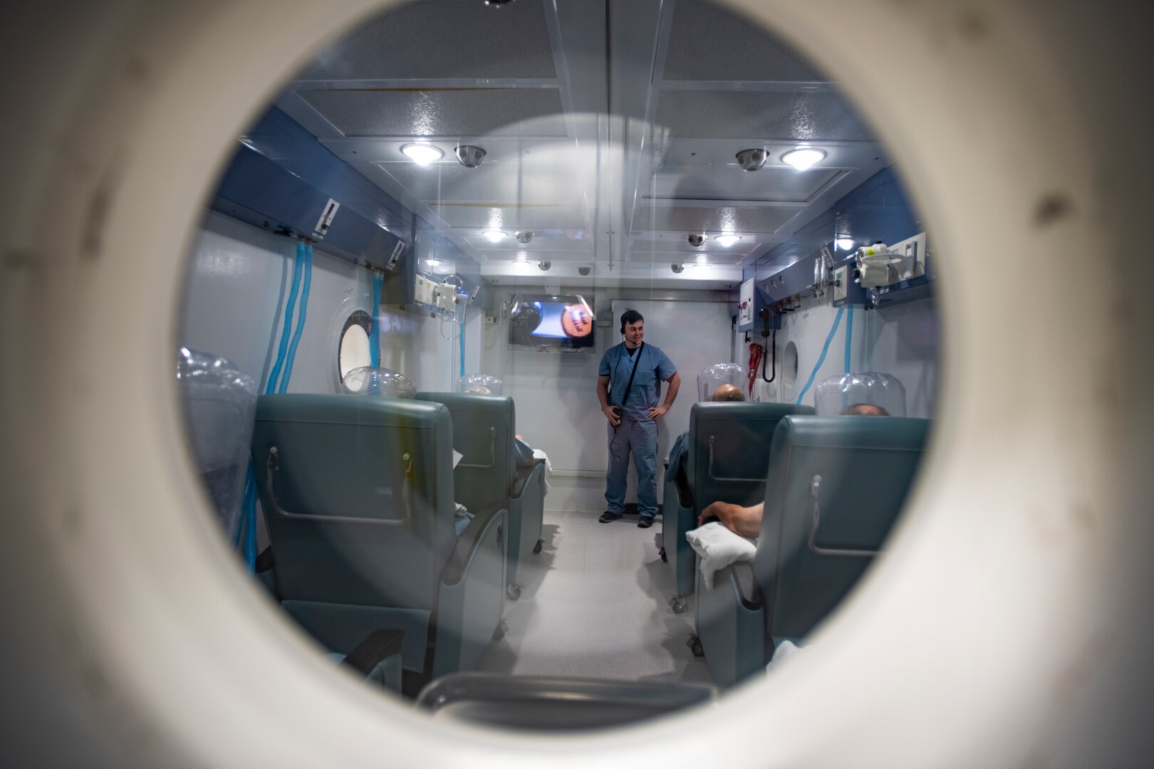 Jeremy Miller, 59th Medical Specialty Squadron hyperbarics licensed practical nurse, monitors patients inside a hyperbaric chamber at Brooke Army Medical Center at Joint Base San Antonio-Fort Sam Houston May 31. The hyperbaric facility at BAMC gets referrals from throughout the Defense Department, as well as from civilian trauma and burn centers in the San Antonio area.