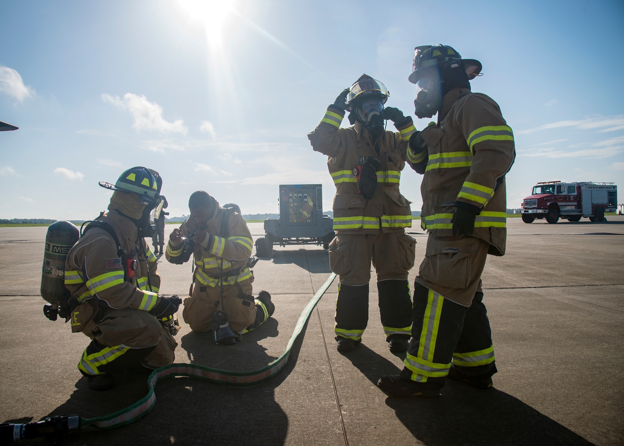 Firefighters from the 23d Civil Engineer Squadron (CES), don personal protective gear prior to HC-130J Combat King II egress training, July 11, 2019, at Moody Air Force Base, Ga. Firefighters conducted the training to evaluate their overall knowledge and proficiency of how to properly shut down and rescue personnel from a C-130 during an emergency situation. (U.S. Air Force photo by Airman 1st Class Eugene Oliver)