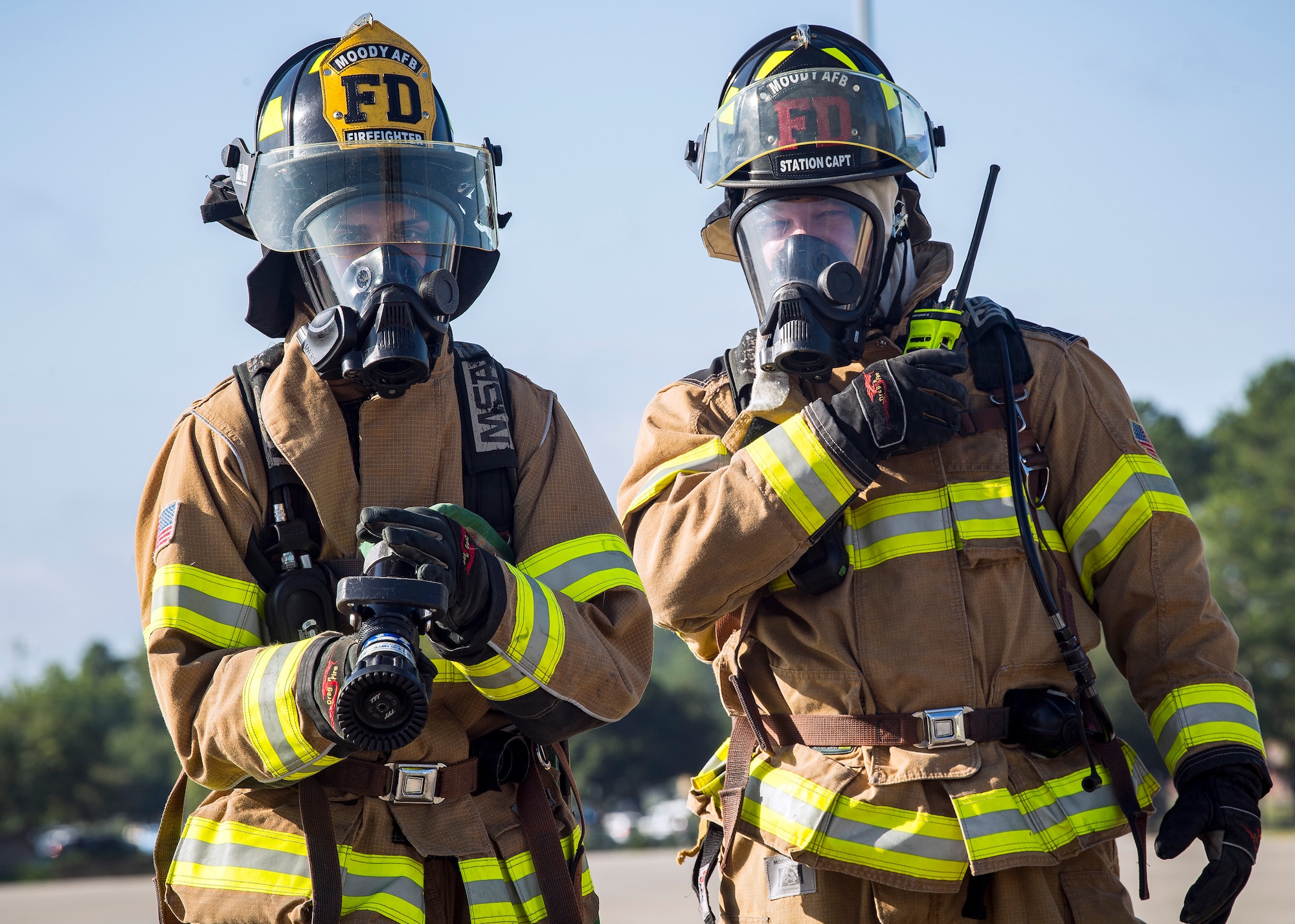 Tech. Sgt. Garey Schmidt, right, 23d Civil Engineer Squadron (CES) firefighter station chief, gives instruction during HC-130J Combat King II egress training, July 11, 2019, at Moody Air force Base, Ga. Firefighters conducted the training to evaluate their overall knowledge and proficiency of how to properly shut down and rescue personnel from a C-130 during an emergency situation. The training required the firefighters to properly enter and ventilate the aircraft while conducting swift rescue techniques to safely locate and remove passengers from the aircraft. (U.S. Air Force photo by Airman 1st Class Eugene Oliver)