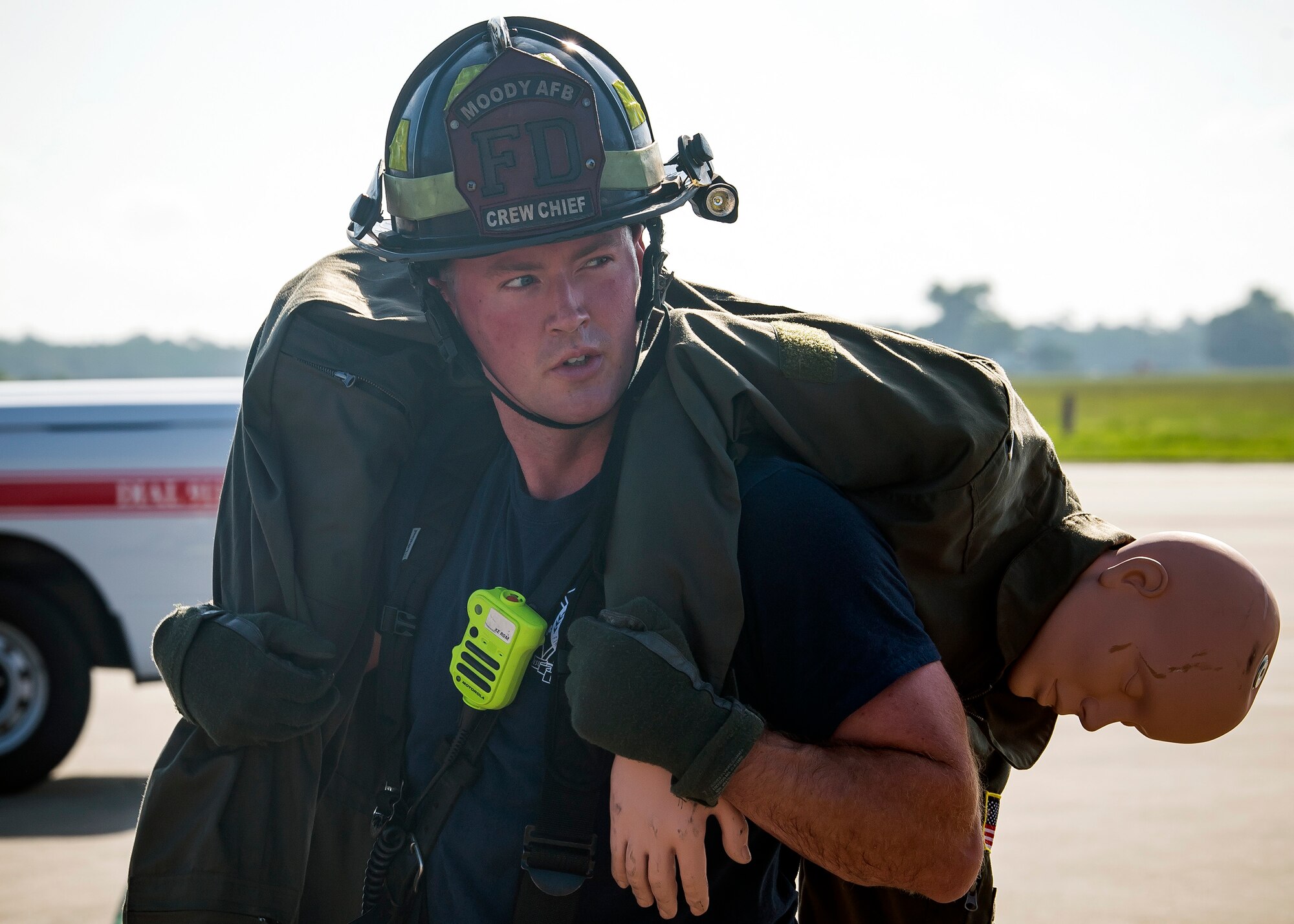Donald Carey, 23d Civil Engineer Squadron (CES) crew chief, carries a simulated aircrew member during HC-130J Combat King II egress training, July 11, 2019, at Moody Air Force Base, Ga. Firefighters conducted the training to evaluate their overall knowledge and proficiency of how to properly shut down and rescue personnel from a C-130 during an emergency situation. The training required the firefighters to properly enter and ventilate the aircraft while conducting swift rescue techniques to safely locate and remove passengers from the aircraft. (U.S. Air Force photo by Airman 1st Class Eugene Oliver)
