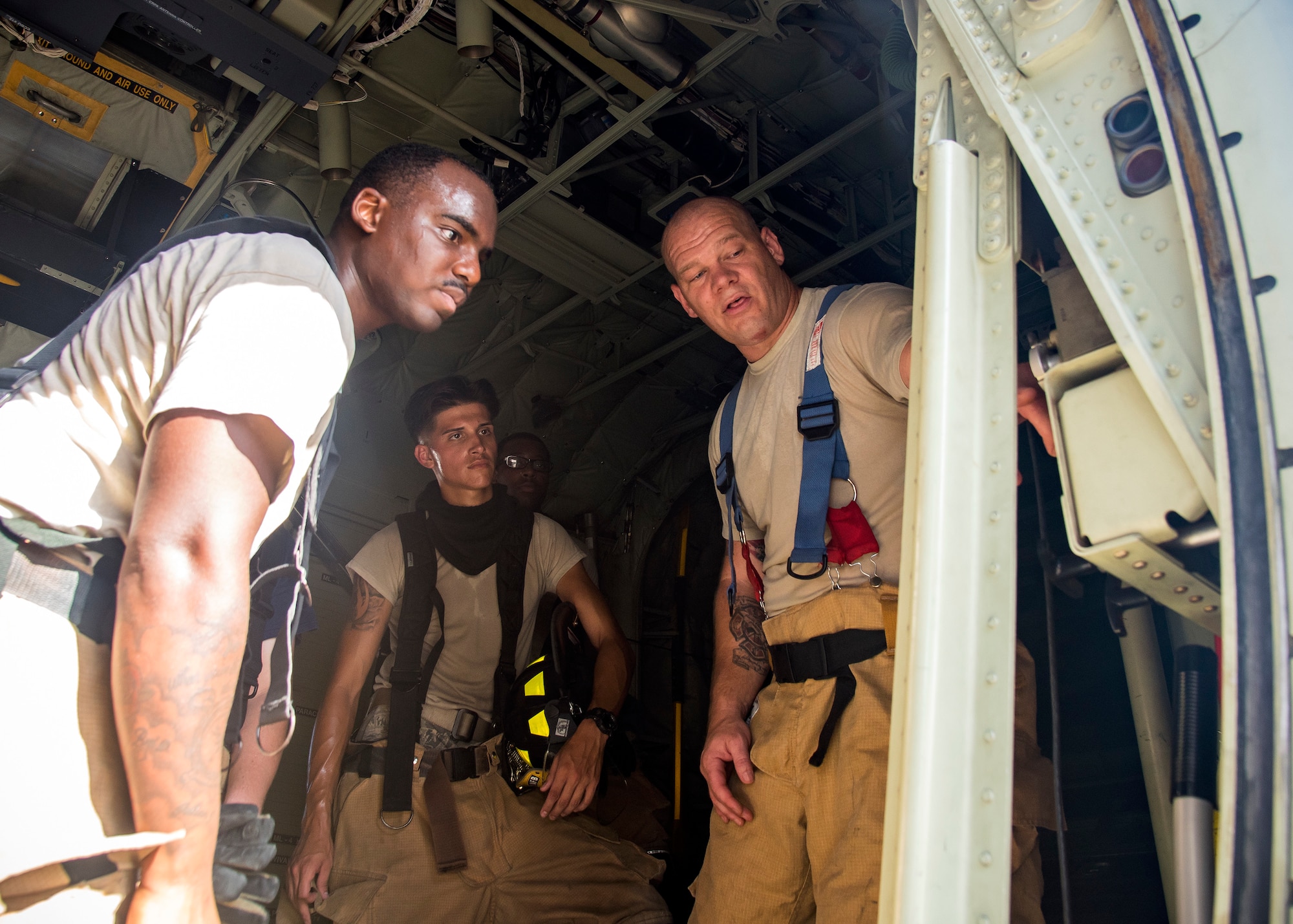 Tech. Sgt. Garey Schmidt, right, 23d Civil Engineer Squadron (CES) firefighter station chief, explains the internal components of an HC-130J Combat King II following egress training, July 11, 2019, at Moody Air Force Base, Ga. Firefighters conducted the training to evaluate their overall knowledge and proficiency of how to properly shut down and rescue personnel from a C-130 during an emergency situation. The training required the firefighters to properly enter and ventilate the aircraft while conducting swift rescue techniques to safely locate and remove passengers from the aircraft. (U.S. Air Force photo by Airman 1st Class Eugene Oliver)