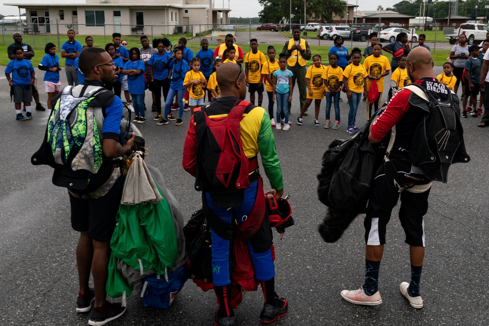 Members of the Team Blackstar Skydivers Demonstration Team talk to kids during the Eyes Above the Horizon diversity outreach program, July 13, 2019, in Valdosta, Ga. The Valdosta Regional Airport hosted the Legacy Flight Academy and over 60 youths ranging in age from 10-19 for a day of flight introduction and immersion into the legacy of the historic Tuskegee Airmen. The program is designed to remove barriers for underrepresented minorities and inspire an interest in aerospace careers. (U.S. Air Force photo by Airman 1st Class Hayden Legg)
