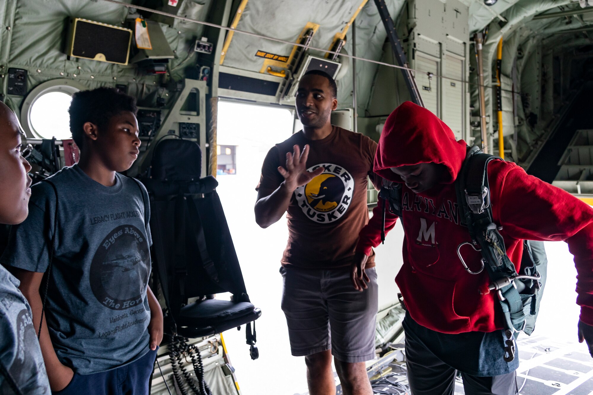 A participant tries on a parachute during the Eyes Above the Horizon diversity outreach program, July 13, 2019, in Valdosta, Ga. The Valdosta Regional Airport hosted the Legacy Flight Academy and over 60 youths ranging in age from 10-19 for a day of flight introduction and immersion into the legacy of the historic Tuskegee Airmen. The program is designed to remove barriers for underrepresented minorities and inspire an interest in aerospace careers. (U.S. Air Force photo by Airman 1st Class Hayden Legg)