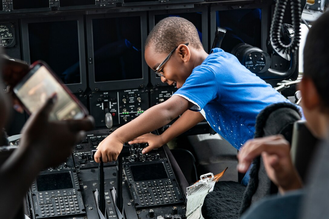 A participant moves the throttle of an HC-130J Combat King II during the Eyes Above the Horizon diversity outreach program, July 13, 2019, in Valdosta, Ga. The Valdosta Regional Airport hosted the Legacy Flight Academy and over 60 youths ranging in age from 10-19 for a day of flight introduction and immersion into the legacy of the historic Tuskegee Airmen. The program is designed to remove barriers for underrepresented minorities and inspire an interest in aerospace careers. (U.S. Air Force photo by Airman 1st Class Hayden Legg)
