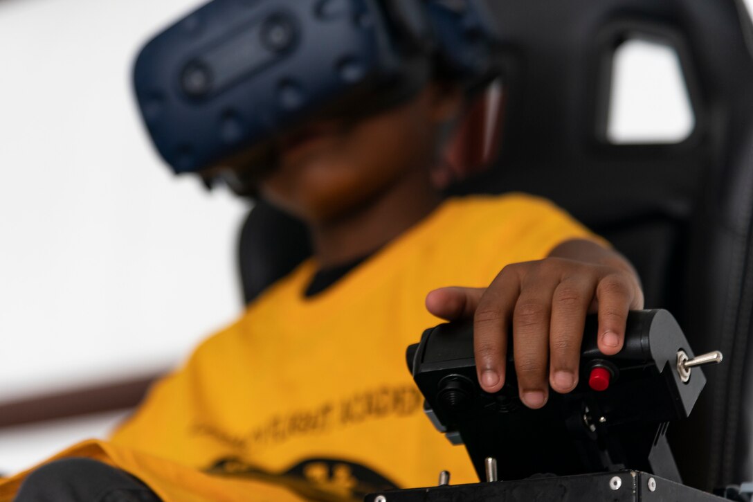 A participant uses a virtual reality flight simulator during the Eyes Above the Horizon diversity outreach program, July 13, 2019, in Valdosta, Ga. The Valdosta Regional Airport hosted the Legacy Flight Academy and over 60 youths ranging in age from 10-19 for a day of flight introduction and immersion into the legacy of the historic Tuskegee Airmen. The program is designed to remove barriers for underrepresented minorities and inspire an interest in aerospace careers. (U.S. Air Force photo by Airman 1st Class Hayden Legg)