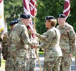 Lt. Gen. Nadja Y. West (center), Army Surgeon General and commanding general, U.S. Army Medical Command, passes the guidon to Brig. Gen. George “Ned” Appenzeller as Brig. Gen. Jeffrey J. Johnson relinquished command of the Regional Health Command-Central in a change of command ceremony today at the Quadrangle at Joint Base San Antonio-Fort Sam Houston July 16.