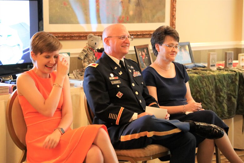 The Heuser Family shares a laugh at the retirement ceremony for Army Reserve Col. Todd M. Heuser (center), who retired July 13, 2019, after a 30-year military career. Picture with Heuser are his daughter Ashley (left) and wife Shelley.