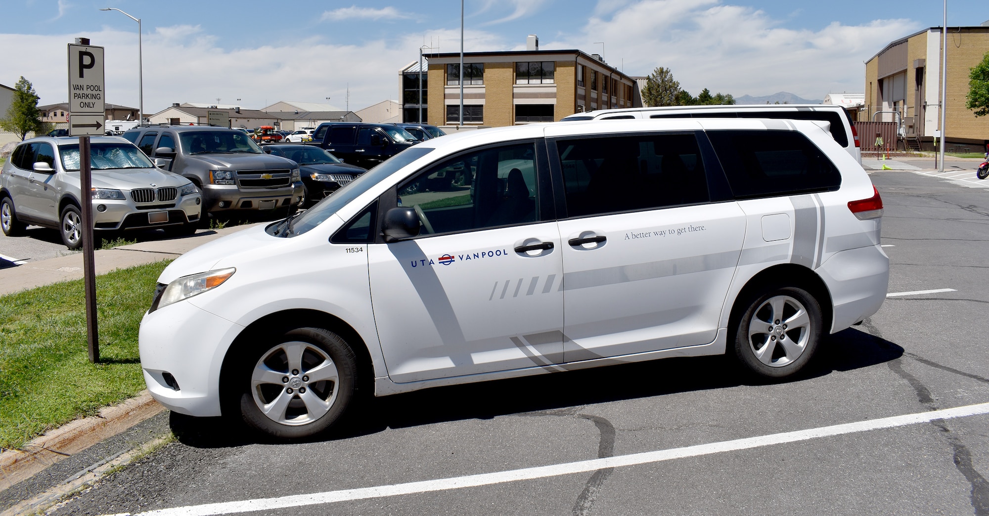 A Utah Transit Authority vanpool vehicle parked near building 100 at Hill Air Force Base, Utah, July 16, 2019. Hill AFB employees are saving money with the base public transit commuter program. The program, officially called the Transportation Incentive Program, has about 650 participants and more than 160 Utah Transit Authority vans that run on base.Vans have various pick up and drop off locations, including FrontRunner stations close to the base. (U.S. Air Force photo) (This photo has been altered by blurring out license plates.)