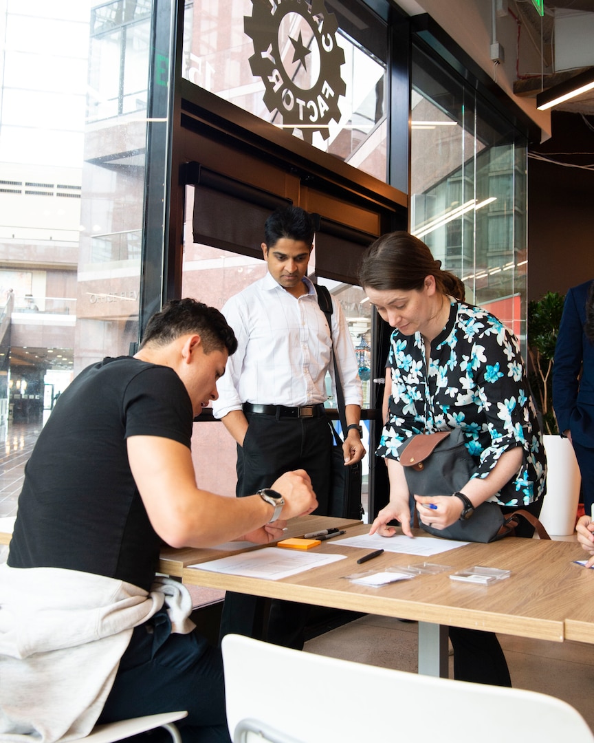 Attendees of the Project NEXUS kickoff event sign in at the AFWERX Austin Hub July 8, 2019. NEXUS, a tech boot camp, will train Airmen from various backgrounds in data, software development and application design. The style of training was chosen for Project NEXUS because its learn-by-doing focus has already proven viable in the open market. (U.S. Air Force photo by Staff Sgt. Jordyn Fetter)