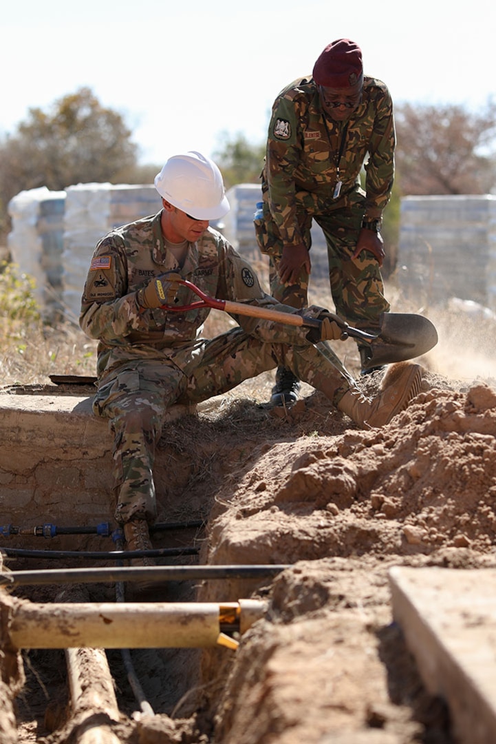 Spc. Adam Bates, with the North Carolina National Guard’s 882nd Engineer Company, shovels dirt from around water and sewer pipes while his Botswana Defense Force counterpart advises, in preparation for replacing a sewer line at Thebephatshwa Airbase in Botswana on July 11, 2019. This was one of several projects conducted in partnership with North Carolina, Alabama and New Jersey National Guards and the Botswanan Defense Force during Upward Minuteman 2019, a U.S. Africa Command exercise promoting the U.S. National Guard’s State Partnership Programs on the African Continent.