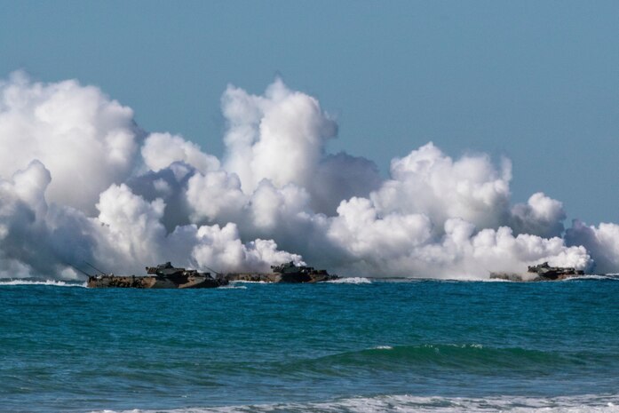 U.S. Marine amphibious assault vehicles give off tactical smoke as they approach Langham Beach, Queensland, Australia, July16, during Exercise Talisman Sabre 2019. Talisman Sabre 19 is a bilateral exercise that provides U.S. and Australian forces realistic and relevant training to strengthen regional security, peace and stability.