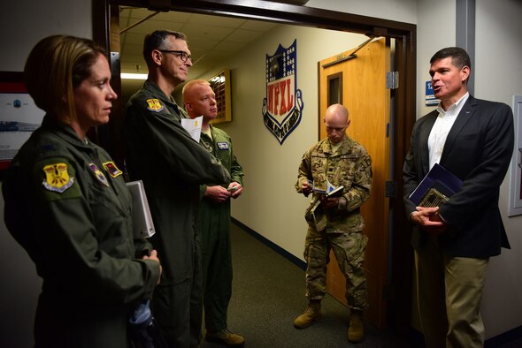 John Henderson, assistant Secretary of the Air Force for installations environment and energy, and Maj. Gen. Craig Wills, 19th Air Force commander, discuss possible problem solutions with senior leadership at Laughlin Air Force Base, Texas, July 15, 2019. While walking through Anderson Hall the group discussed pilot production increase, innovation and educational campus needs. (U.S. Air Force photo by Airman 1st Class Marco A. Gomez)