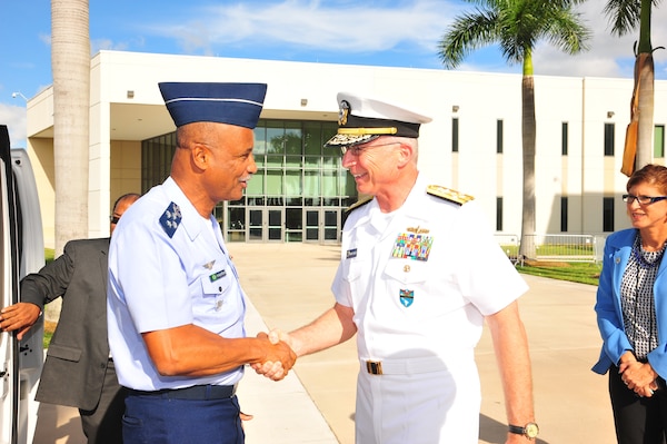 Military leaders shake hands.