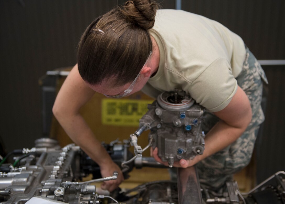 U.S. Air Force Airman 1st Class Natalie Brandt, Detachment 1, 362nd Training Squadron student, removes an engine component during a UH-60 Helicopter Repairer course at Joint Base Langley-Eustis, Virginia, July 15, 2019.