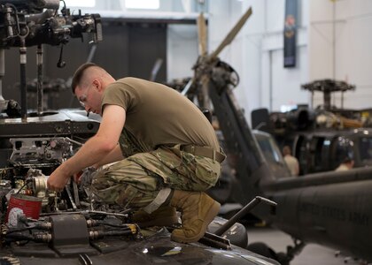 U.S. Army Pfc. Caleb Smith, Charlie Company, 222nd Aviation Regiment, 1st Aviation Battalion, 128th Aviation Brigade Advanced Individual Training student, examines an engine component during a UH-60 Helicopter Repairer course at Joint Base Langley-Eustis, Virginia, July 15, 2019.