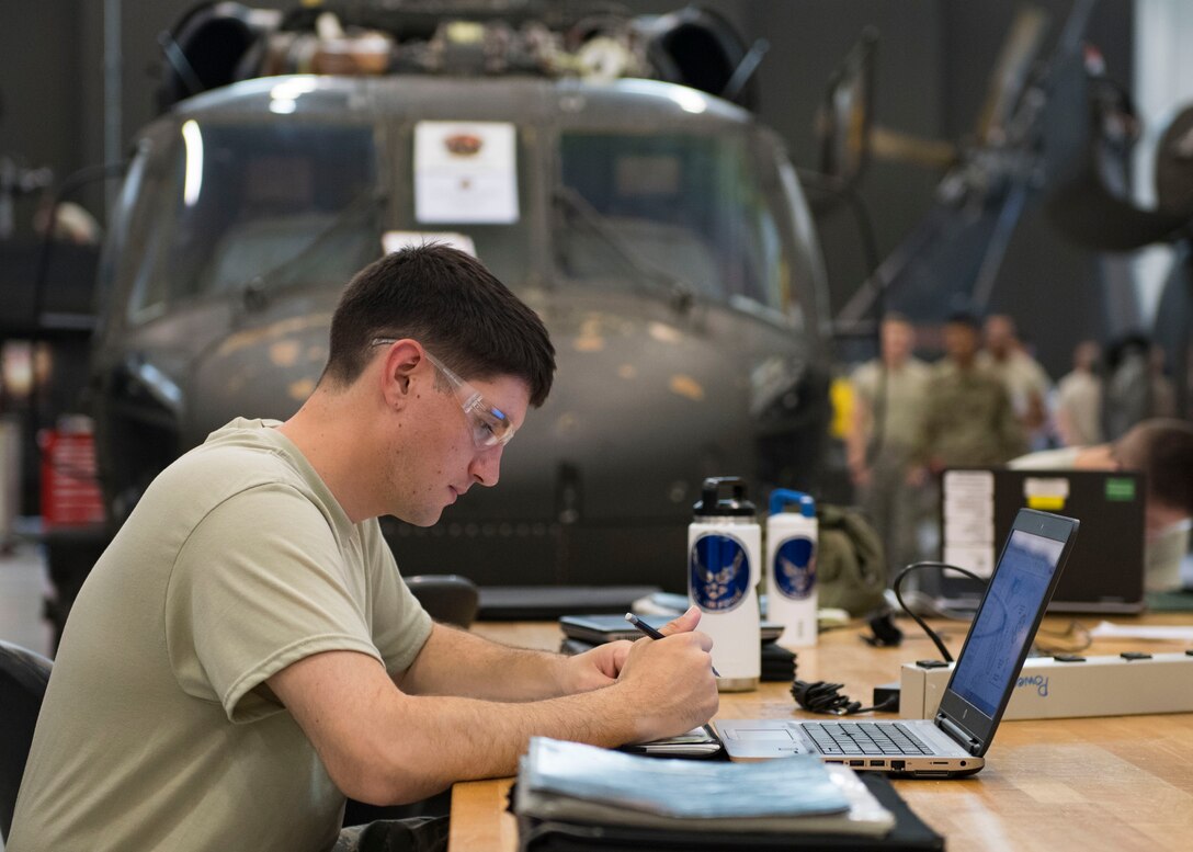 U.S. Air Force Airman Daniel Welcome, Detachment 1, 362nd Training Squadron student, studies notes during a UH-60 Helicopter Repairer course at Joint Base Langley-Eustis, Virginia, July 15, 2019.