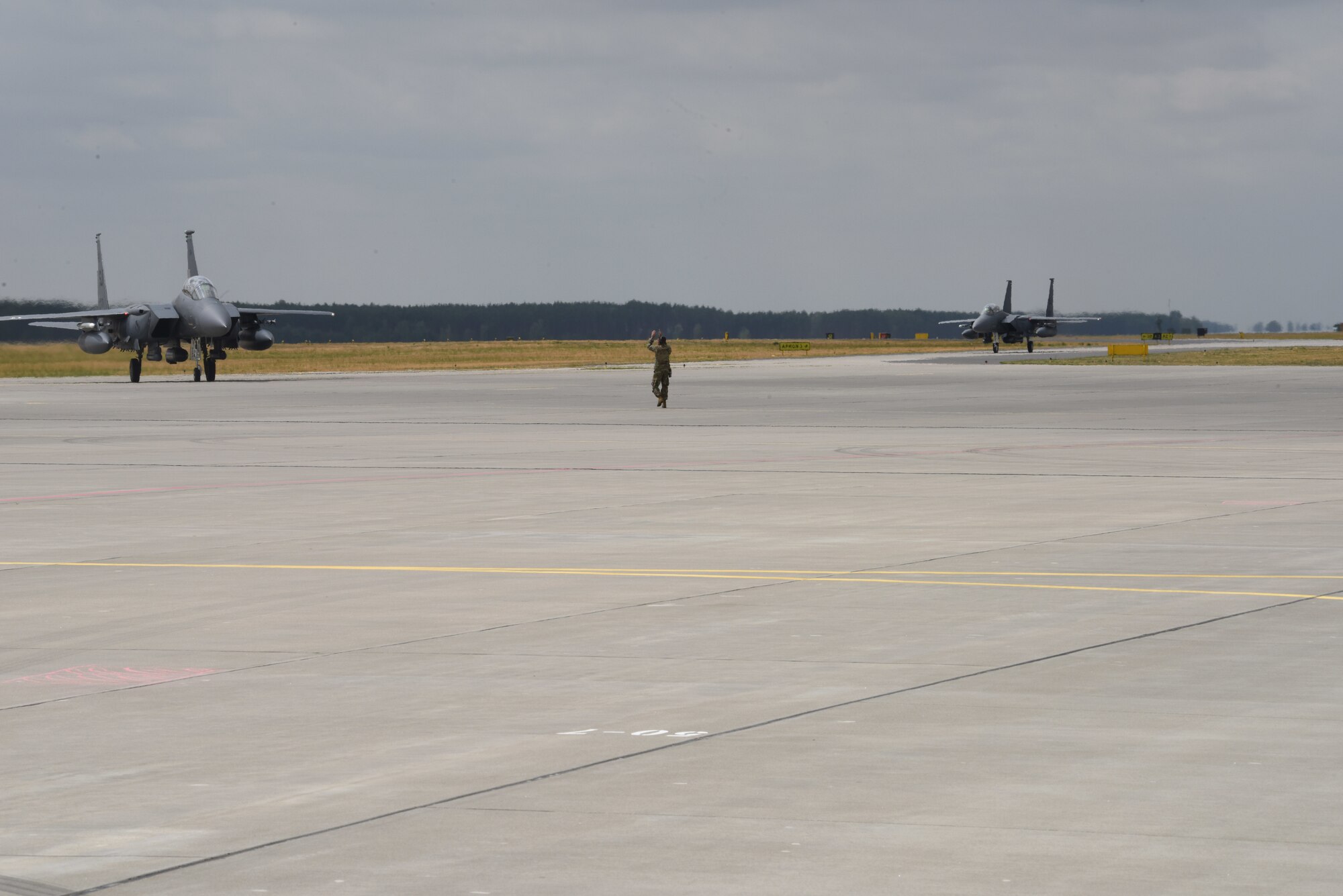 Two F-15 Strike Eagle aircraft deployed from the 336th Fighter Squadron, 4th Fighter Wing, Seymour Johnson Air Force Base, N.C., taxi on a runway during Operation Rapid Forge on Powidz Air Base, Poland, July, 16, 2019. Rapid Forge is a U.S. Air Forces in Europe-led mission to enhance readiness and test the ability to function at locations other than the main air bases.