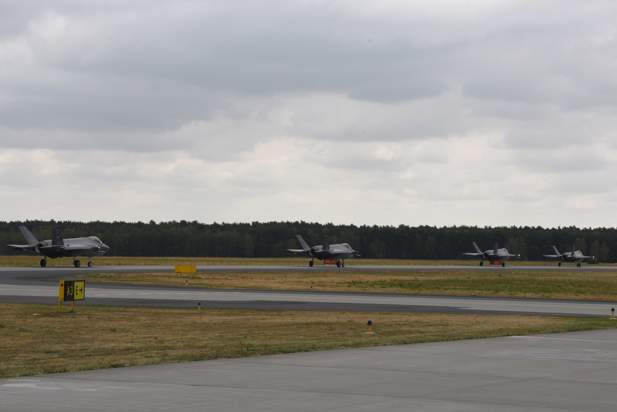 Four U.S. Air Force F-35A Lightning II aircraft deployed from the 388th and 419th Fighter Wings, Hill Air Force Base, Utah, taxi on a runway during Operation Rapid Forge at Powidz Air Base, Poland, July, 16, 2019. This is the first time that U.S. Air Force F-35A Lightning II aircraft have landed in Poland. Operation Rapid Forge is intended to enhance interoperability with NATO allies to improve combined operational capabilities.