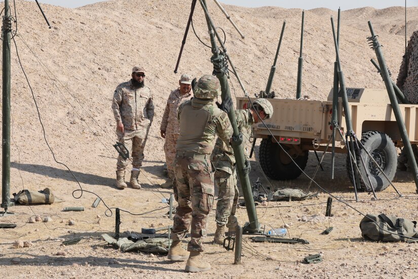 U.S. Soldiers from the 588th Brigade Engineer Battalion, 3rd Armored Brigade Combat Team, 4th Infantry Division, set up a quick erect antenna mast as part of radio retransmission (RETRANS) training just outside of Camp Buehring, Kuwait, while Kuwait Land Forces Soldiers observe. The U.S. and KLF Soldiers trained together on RETRANS tasks several times over the course of two weeks, leading up to a final validating event for the 588th Soldiers.