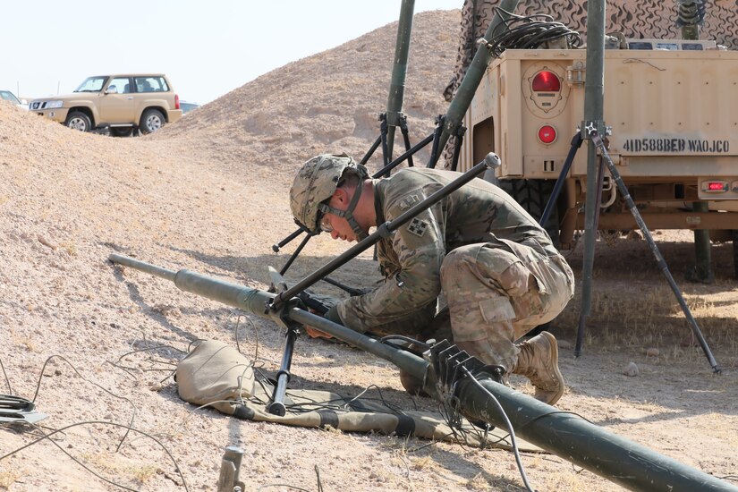 Spc. Brennan, a signal Soldier with 588th Brigade Engineer Battalion, 3rd Armored Brigade Combat Team, 4th Infantry Division, works to install a quick erect antenna mast (QEAM) during a radio retransmission (RETRANS) training validation event outside of Camp Buehring, Kuwait Wednesday, July 10. RETRANS teams trained for several weeks leading up to the validation exercise.