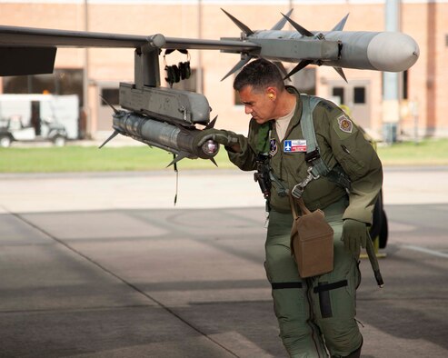 Lt. Gen. Marc Sasseville, Continental U.S. NORAD Region-1st Air Force (Air Forces Northern) Commander, inspects an AIM-9X Sidewinder missile on an F-16 Fighting Falcon prior to a flight for the F-16 Senior Officer Course, hosted by the 149th Fighter Wing, Joint Base San Antonio, Texas. The four-week course, designed to requalify experienced F-16 fighter pilots, focused on advanced handling characteristics, tactical formation and instrument-flying procedures. He also regained his air-air refueling currency during the course along with flying basic fighter maneuvers. He was required to requalify in the fighter jet based on his roles and responsibilities as the CONR-1 AF (AFNORTH) Commander. (Air Force photo by Capt. Cindy Piccirillo)