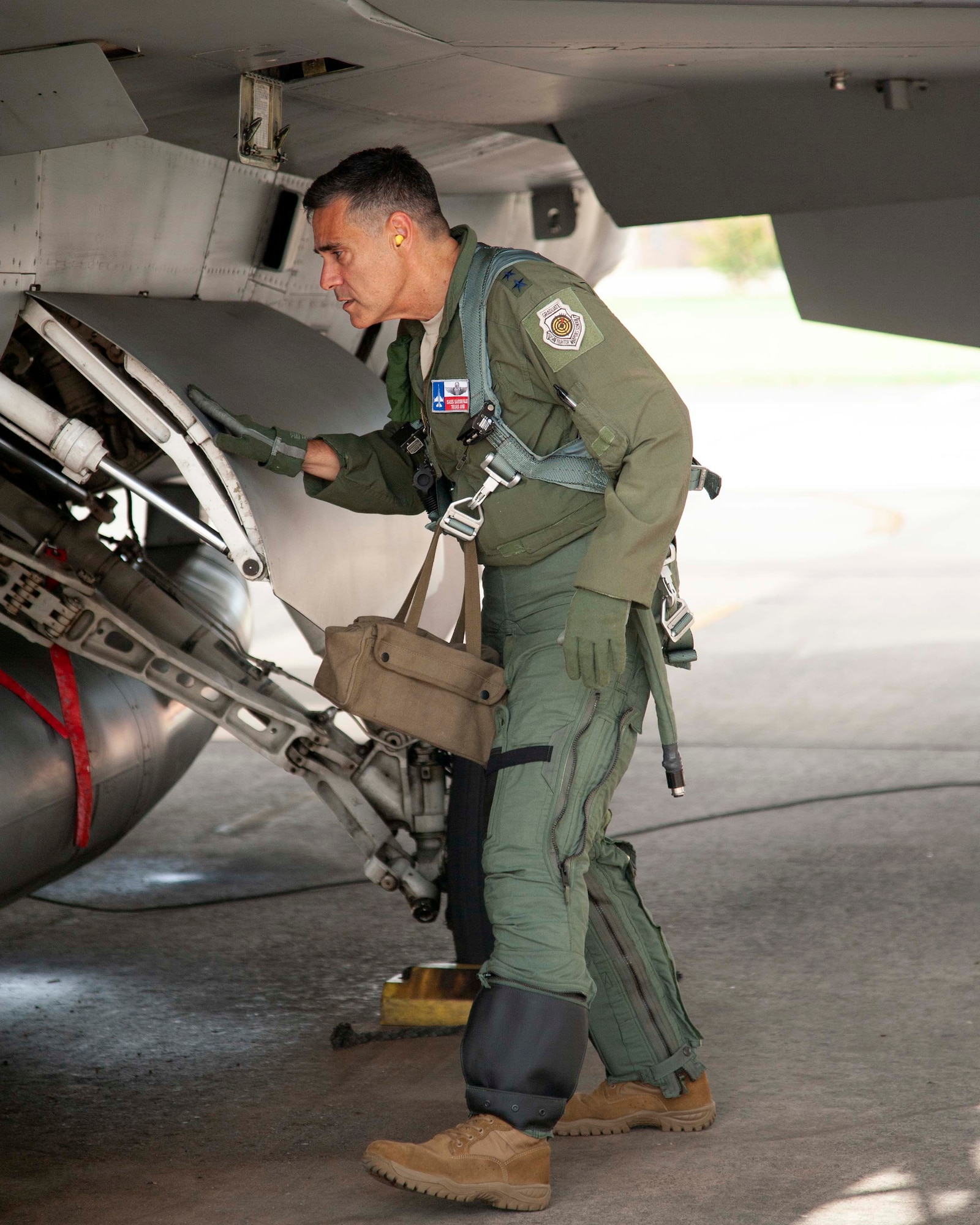 2.	Lt. Gen. Marc Sasseville, Continental U.S. NORAD Region-1st Air Force (Air Forces Northern) Commander, looks over the landing gear during a pre-flight walk-around on an F-16 Fighting Falcon prior to a flight for the F-16 Senior Officer Course, hosted by the 149th Fighter Wing, Joint Base San Antonio, Texas. The four-week course, designed to requalify experienced F-16 fighter pilots, focused on advanced handling characteristics, tactical formation and instrument-flying procedures. He also regained his air-air refueling currency during the course along with flying basic fighter maneuvers. He was required to requalify in the fighter jet based on his roles and responsibilities as the CONR-1 AF (AFNORTH) Commander. (Air Force photo by Capt. Cindy Piccirillo)