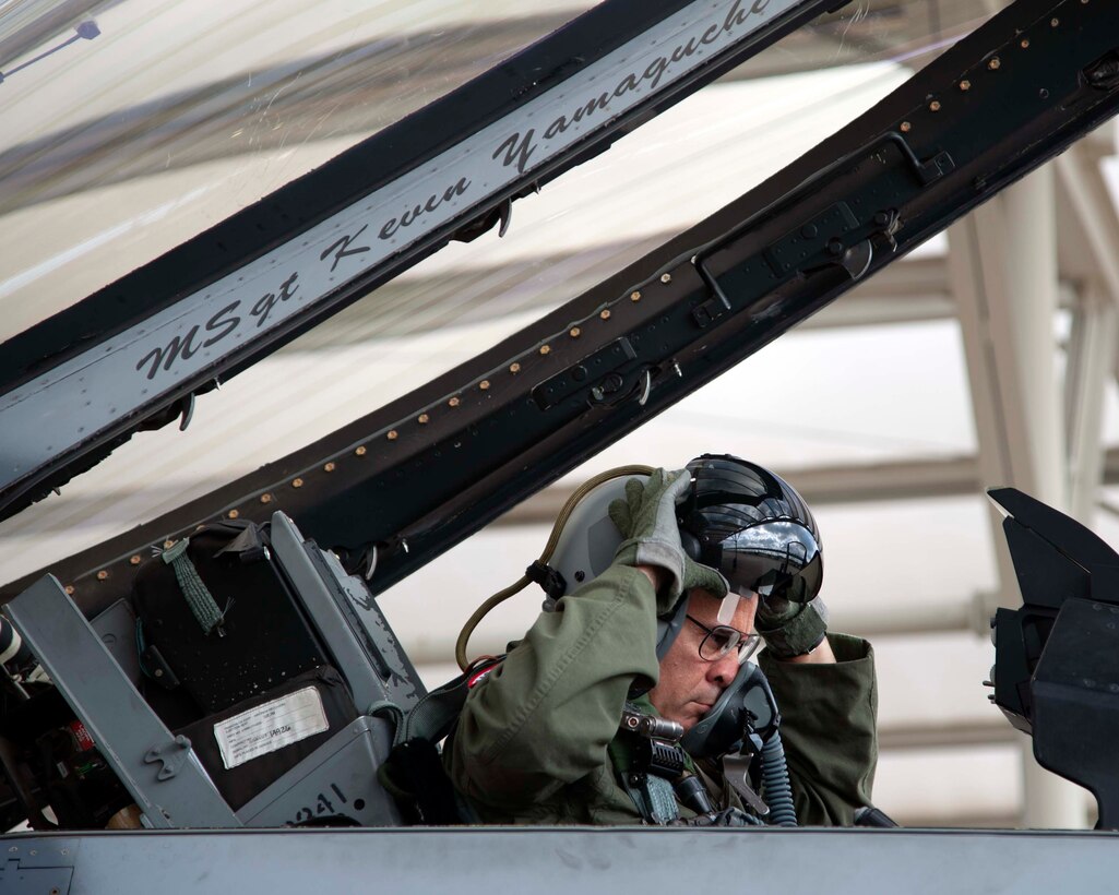 Lt. Gen. Marc Sasseville, Continental U.S. NORAD Region-1st Air Force (Air Forces Northern) Commander, adjusts his helmet that’s fitted with helmet-mounted integrated targeting capability prior to a flight for the F-16 Senior Officer Course, hosted by the 149th Fighter Wing, Joint Base San Antonio, Texas. The four-week course, designed to requalify experienced F-16 fighter pilots, focused on advanced handling characteristics, tactical formation and instrument-flying procedures. He also regained his air-air refueling currency during the course along with flying basic fighter maneuvers. He was required to requalify in the fighter jet based on his roles and responsibilities as the CONR-1 AF (AFNORTH) Commander. (Photo by Capt. Cindy Piccirillo)