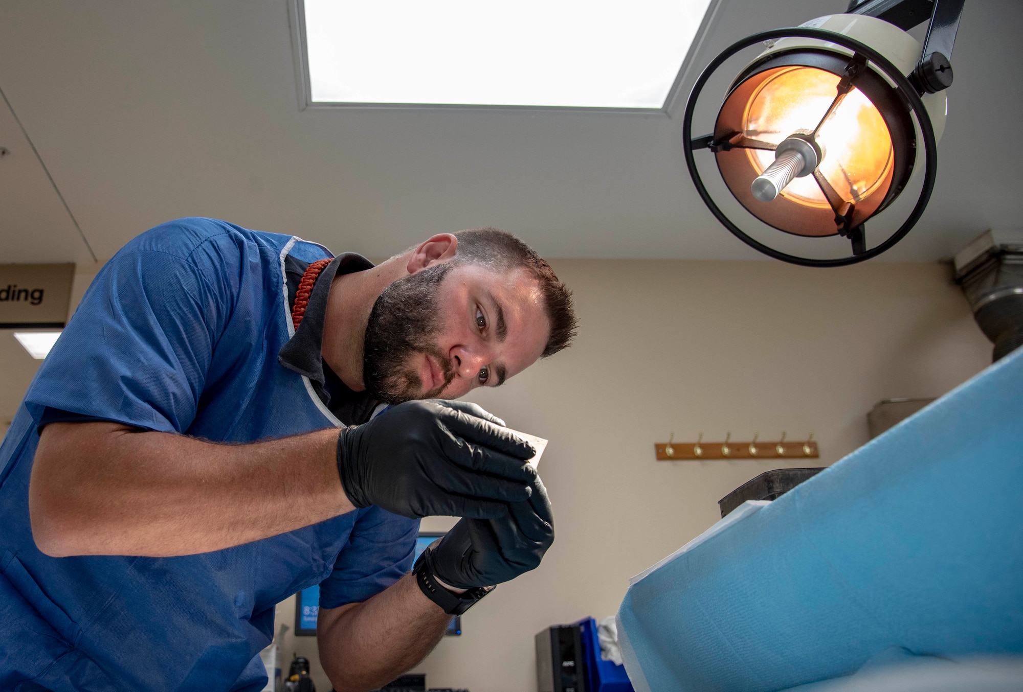 Bryan Thomas Johnson, Federal Bureau of Investigation major incident program manager, examines a possible fingerprint at the Armed Forces Medical Examiner System, Dover Air Force Base, Del., July 9, 2019. Remains found on Colony Glacier are fingerprinted for possible identification. (U.S. Air Force photo by Staff Sgt. Nicole Leidholm)