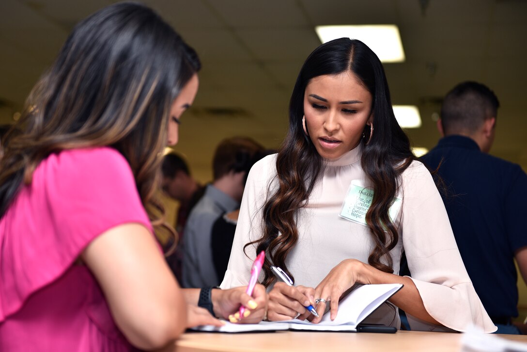 Dulzia Clinton, Air Force Nuclear Weapons Center program manager intern (right), learns about values she shares with Emily Silva, base operational contracting intern, at Kirtland Air Force Base, N.M., July 16, 2019. The Intern “Meet Up” event was created to help create social connections amongst interns working at Kirtland and provide necessary support for their career. (U.S. Air Force photo by Airman 1st Class Austin J. Prisbrey)