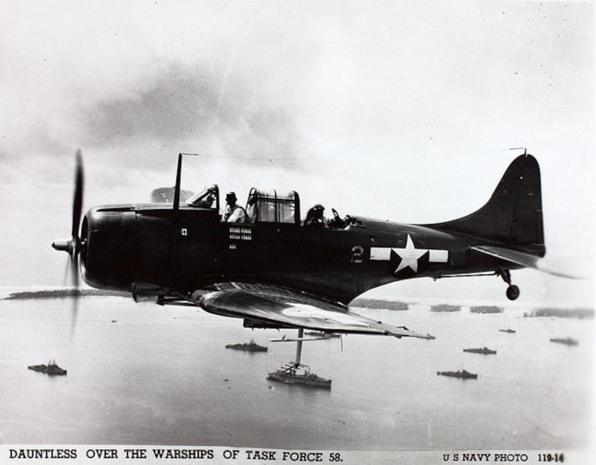 An SBD Douglas dive bomber flying over Task Force 58 in the Marshall Islands on the way to attack targets in the Marianas on June 15, 1944, the day U.S. forces landed on Saipan. It proved to be an excellent Navy scout plane and dive bomber and sank more enemy shipping in the Pacific War than any other Allied aircraft.