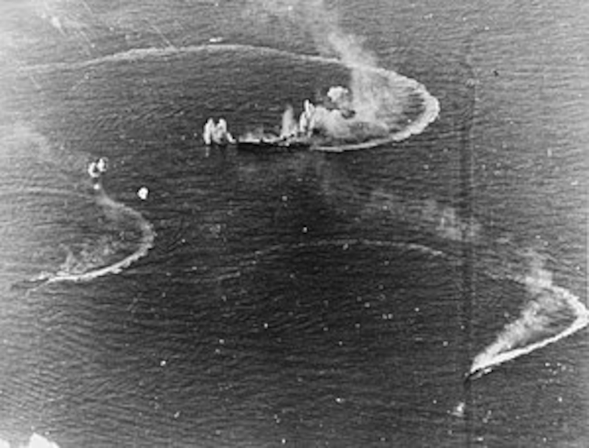 The Japanese carrier Zuikaku (center), which took part in the Japanese attack on Pearl Harbor, Dec. 7, 1941, and two destroyers under attack by Navy carrier aircraft, June 20, 1944. American aircraft sank her in the battle of Cape Engano on Oct. 25, 1944, during the battle of Leyte Gulf.
