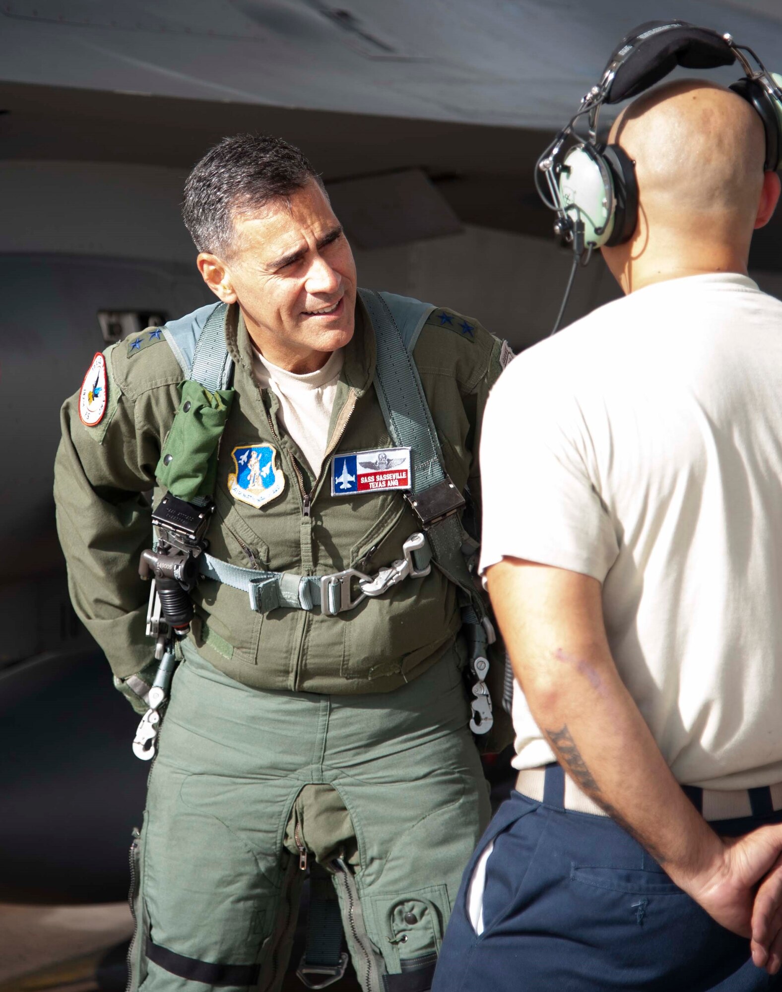 Lt. Gen. Marc Sasseville, Continental U.S. NORAD Region-1st Air Force (Air Forces Northern) Commander, talks with Tech. Sgt. Thomas Corral, F-16 Fighting Falcon crew chief with the 149th Aircraft Maintenance Squadron, prior to a flight for the F-16 Senior Officer Course, hosted by the 149th Fighter Wing at Joint Base San Antonio-Lackland. The four-week course, designed to requalify experienced F-16 fighter pilots, focused on advanced handling characteristics, tactical formation and instrument-flying procedures. He also regained his air-air refueling currency during the course along with flying basic fighter maneuvers. He was required to requalify in the fighter jet based on his roles and responsibilities as the CONR-1 AF (AFNORTH) commander.
