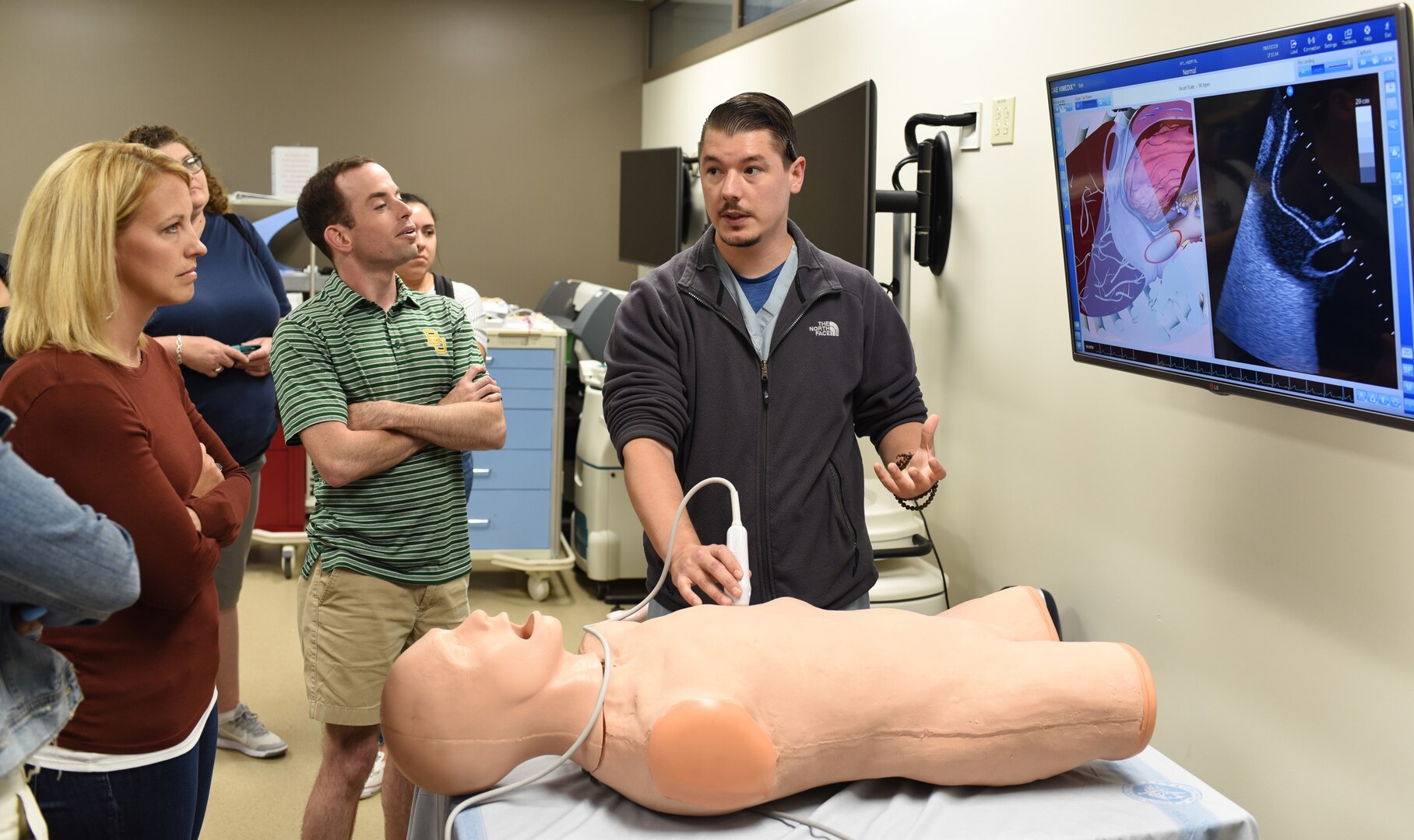 Former Navy Corpsman Donald Cure, lead simulation technician assigned to the Medical-Surgical Simulation Center, Naval Medical Center San Diego, demonstrates an ultrasound scan on a simulation mannequin for educators and counselors from Central and South Texas during Navy Recruiting District San Antonio's Educator Orientation Visit July 9. The EOV is a Navy Recruiting Command program with a main focus of showing educators the various facets of America’s Navy and the many career paths available to students.