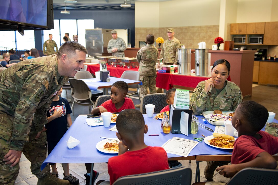Col. Daniel P. Walls, left, 23d Wing Commander, talks with participants of the deployed spouse dinner, July 16, 2019, at Moody Air Force Base, Ga. The dinner served as an opportunity for the families of deployed members to bond and provide relief. The mission’s success depends on resilient Airmen and families, who are prepared to make sacrifices with the support of their fellow Airmen, local communities and leadership. (U.S. Air Force photo by Airman Azaria E. Foster)