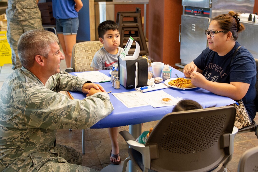 Lt. Col. Thane Sisson, left, 23d Maintenance Squadron commander, talks with a participant of the deployed spouse dinner, July 16, 2019, at Moody Air Force Base, Ga. The dinner served as an opportunity for the families of deployed members to bond and provide relief. The mission’s success depends on resilient Airmen and families, who are prepared to make sacrifices with the support of their fellow Airmen, local communities and leadership. (U.S. Air Force photo by Airman Azaria E. Foster)