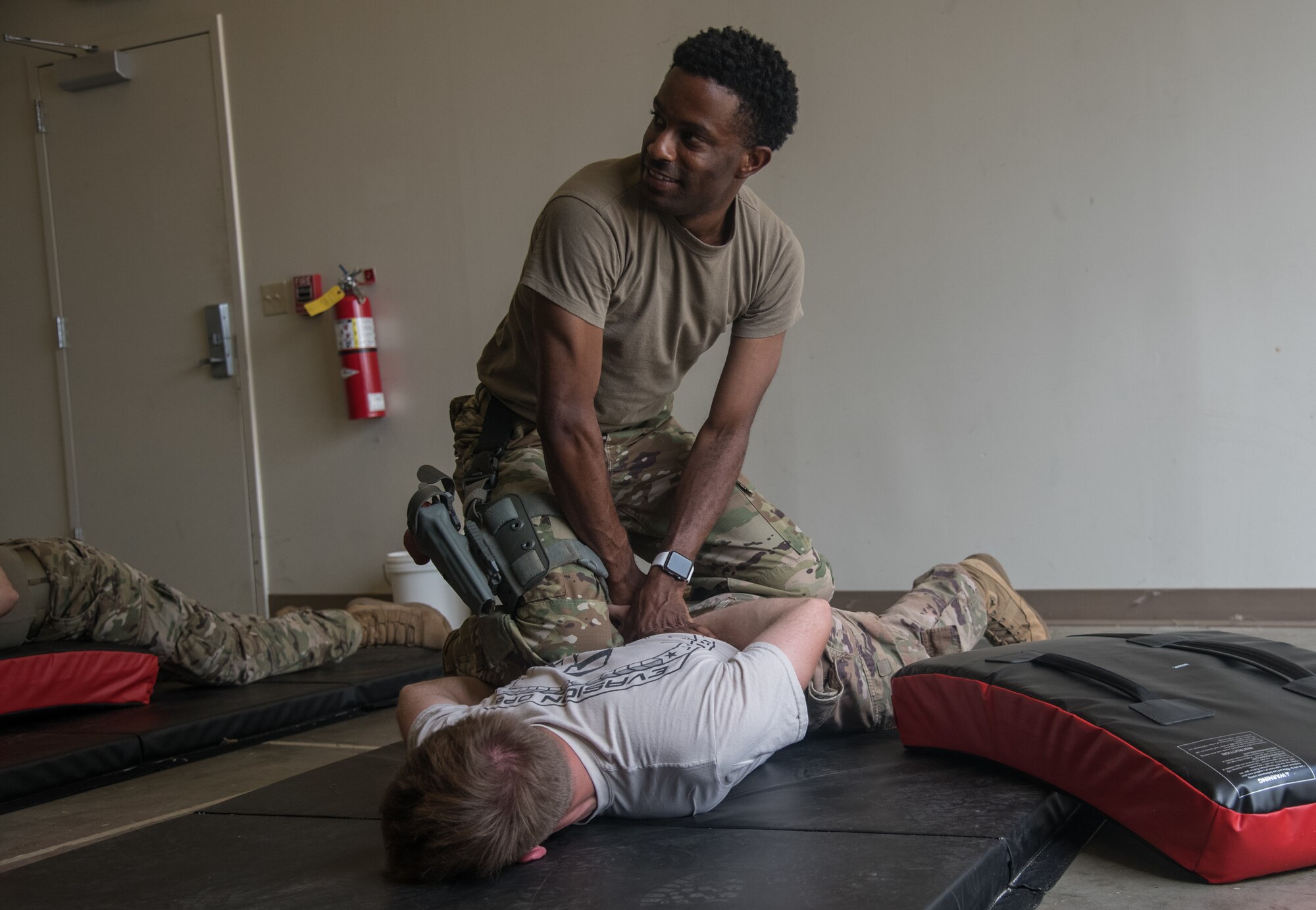 Staff Sgt. D’Angelo Davis, 932nd Security Forces Squadron fireteam member, simulates detaining Staff Sgt. Frederick Viele, 932nd SFS, during baton training July 14, 2019, at Scott Air Force Base, Illinois. The 932nd SFS constantly trains in order to maintain readiness for what ever situation arises. (U.S. Air Force photo by Senior Airman Melissa Estevez)