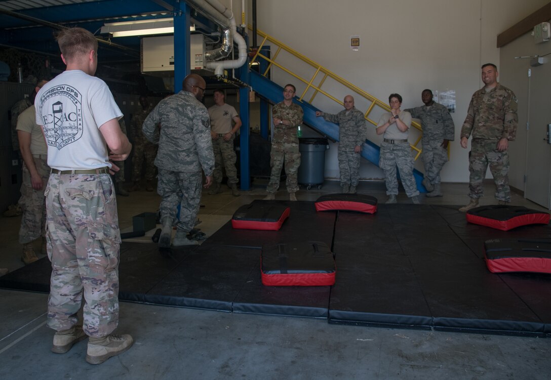 Staff Sgt. Frederick Viele, 932nd Security Forces Squadron, explains the “gauntlet” portion of baton training July 14, 2019, at Scott Air Force Base, Illinois. While in an altercation with an adversary communication is essential. Using verbal commands such as ”stop” or “get back” can help minimize the use of force during an altercation. (U.S. Air Force photo by Senior Airman Melissa Estevez)