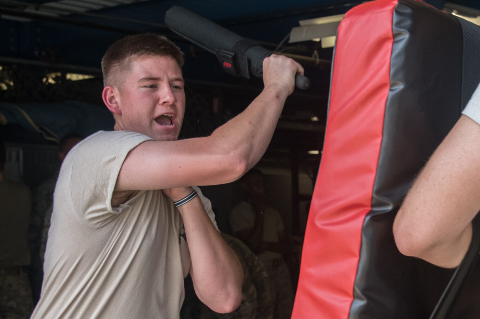 Airman Zach Gamblin, 932nd Security Forces Squadron patrolman, simulates striking an adversary during baton training July 14, 2019, at Scott Air Force Base, Illinois. While in an altercation with an adversary communication is essential. Using verbal commands such as ”stop” or “get back” can help minimize the use of force during an altercation. (U.S. Air Force photo by Senior Airman Melissa Estevez)