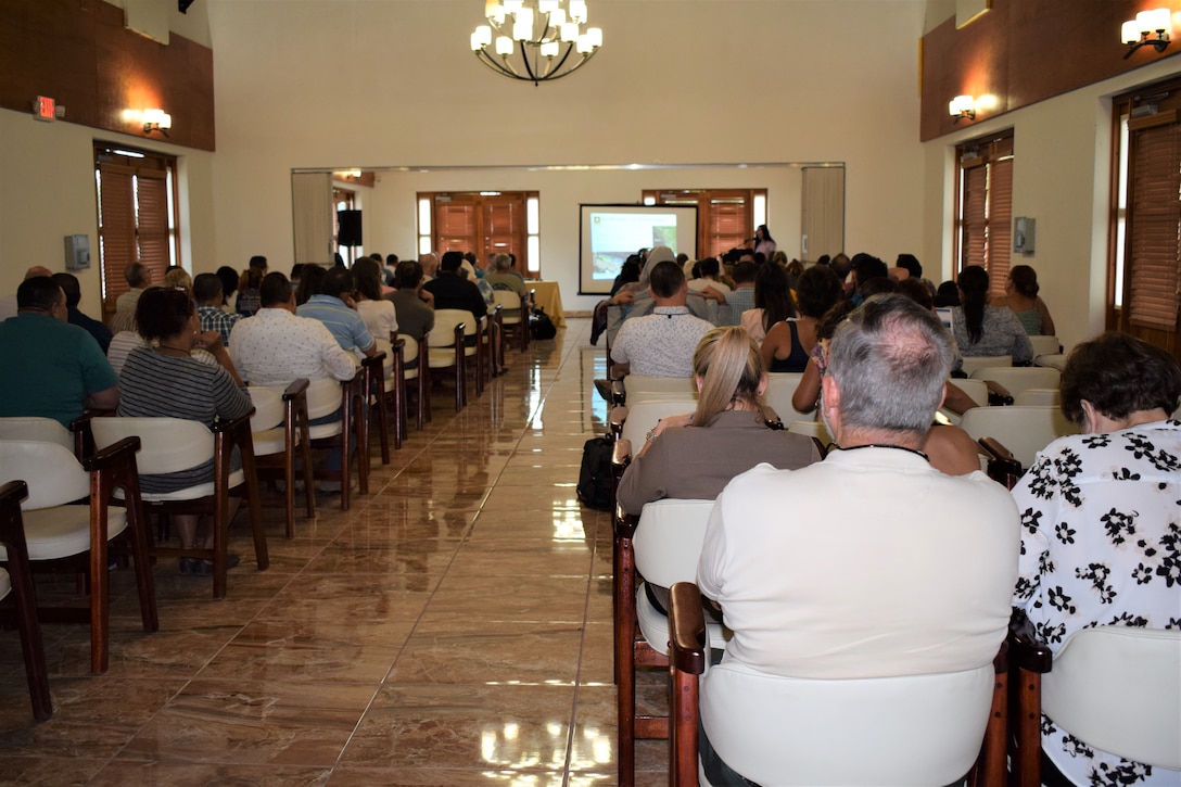 Image taken from the back of the room, approximately 100 attendants seating facing the front of the room.