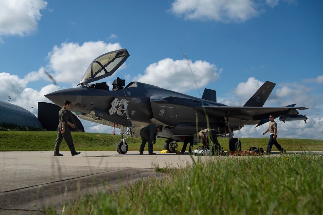 Airmen work on plane.