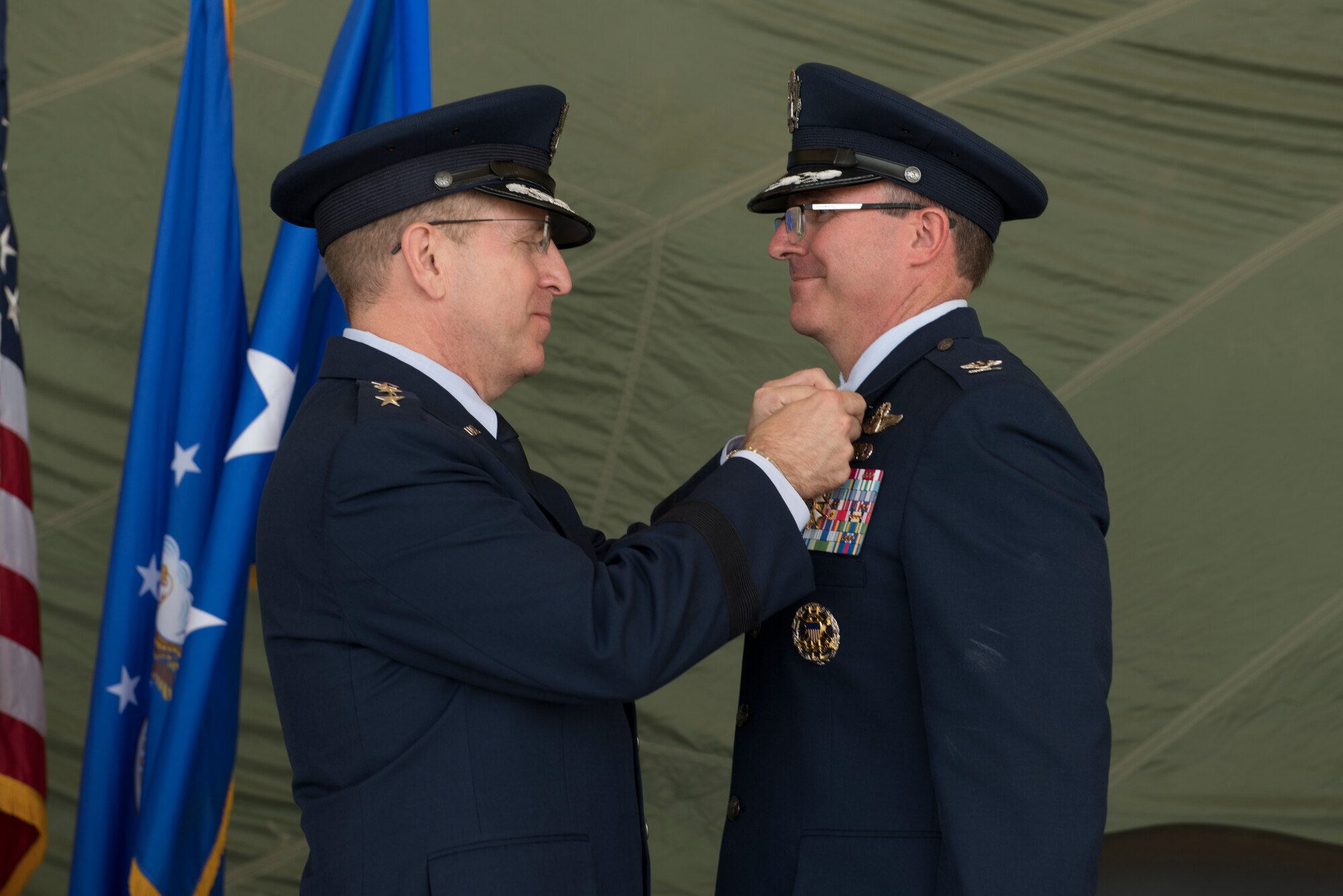 Lt. Gen. Jim Slife, Air Force Special Operations Command commander, pins the Legion of Merit medal on Col. Stewart Hammons, former 27th Special Operations Wing commander, during the change of command ceremony, July 17, 2019, at Cannon Air Force Base, N.M. Col. Robert Masaitis took command from the outgoing commander. (U.S. Air Force photo by Senior Airman Vernon R. Walter III)