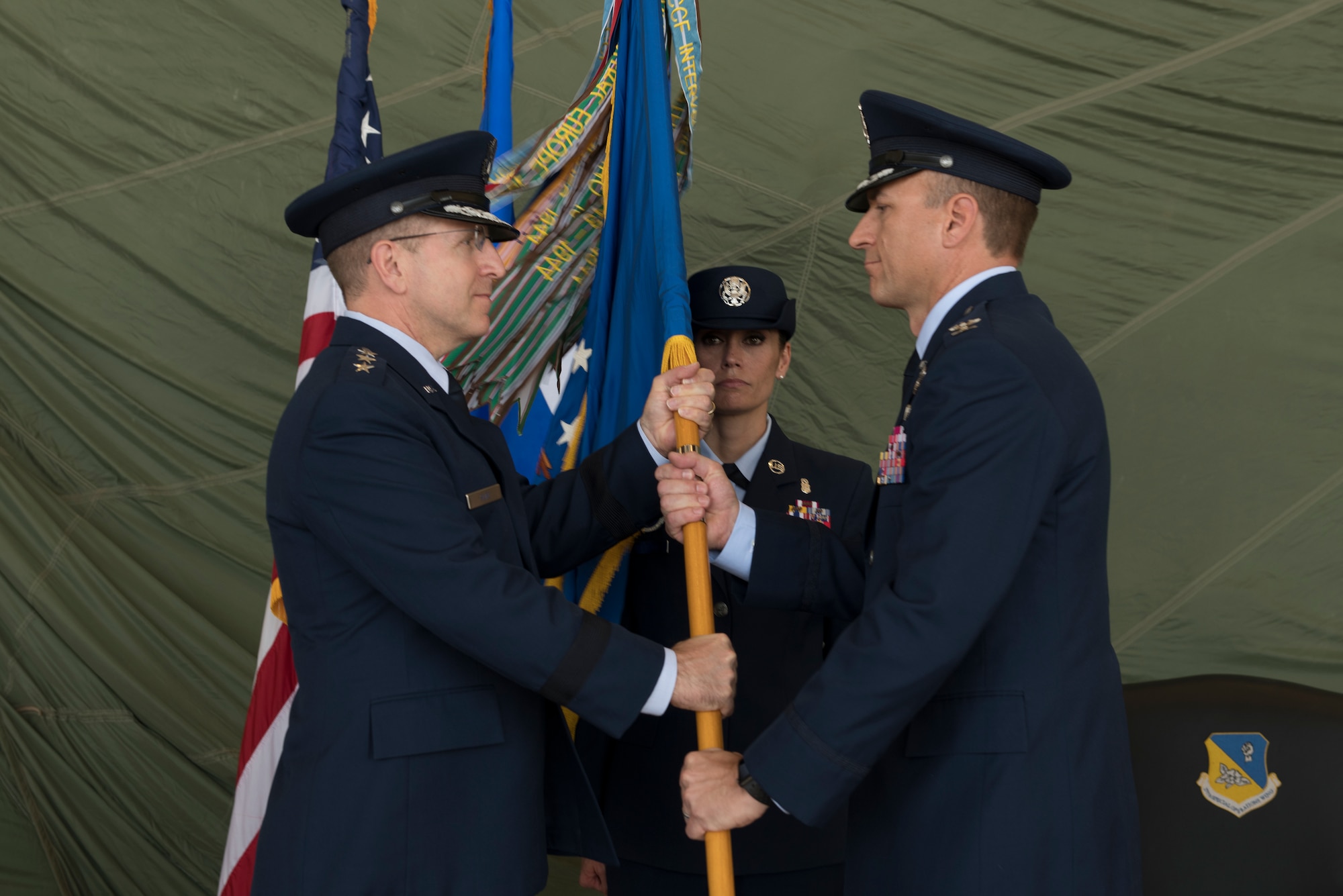Lt. Gen. Jim Slife, Air Force Special Operations Command commander, hands the 27th Special Operations Wing guidon to Col. Robert Masaitis, incoming 27th SOW commander, during the change of command ceremony, July 17, 2019, at Cannon Air Force Base, N.M. Masaitis took command from the outgoing commander, Col. Stewart Hammons. (U.S. Air Force photo by Senior Airman Vernon R. Walter III)