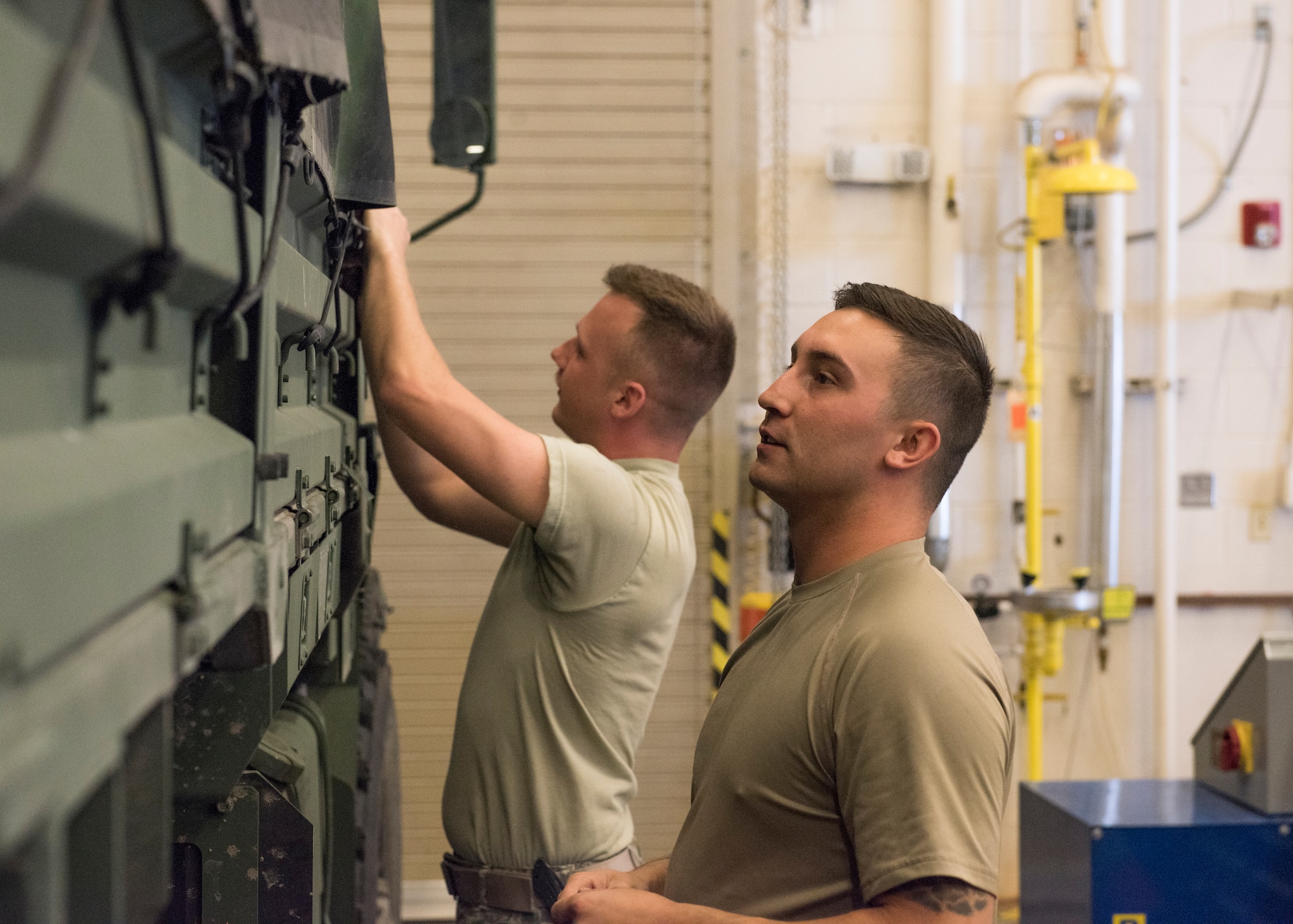 Senior Airman Tyler Duggar, 726th Air Control Squadron, and Senior Airman Randy Johnston, 726th ACS, tie down a Medium Tactical Vehicle cover in preparation for an exercise July 7, 2019, at Mountain Home Air Force Base, Idaho. Airmen from the 726th ACS work around the clock to ensure they are prepared for thier deployment exercises. (U.S. Air Force photo by Senior Airman Tyrell Hall)
