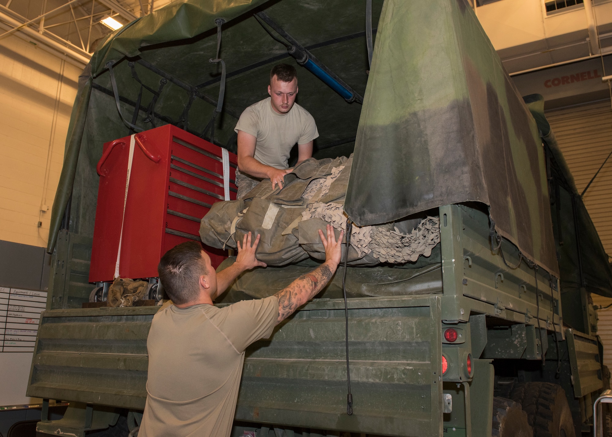 Senior Airman Tyler Duggar, 726th Air Control Squadron, and Senior Airman Randy Johnston, 726th ACS, load suppliies onto a Medium Tactical Vehicle in preparation for an exercise July 7, 2019, at Mountain Home Air Force Base, Idaho. The 726th ACS Conducts deployment exercises in order to increase their mission readiness. (U.S. Air Force photo by Senior Airman Tyrell Hall)