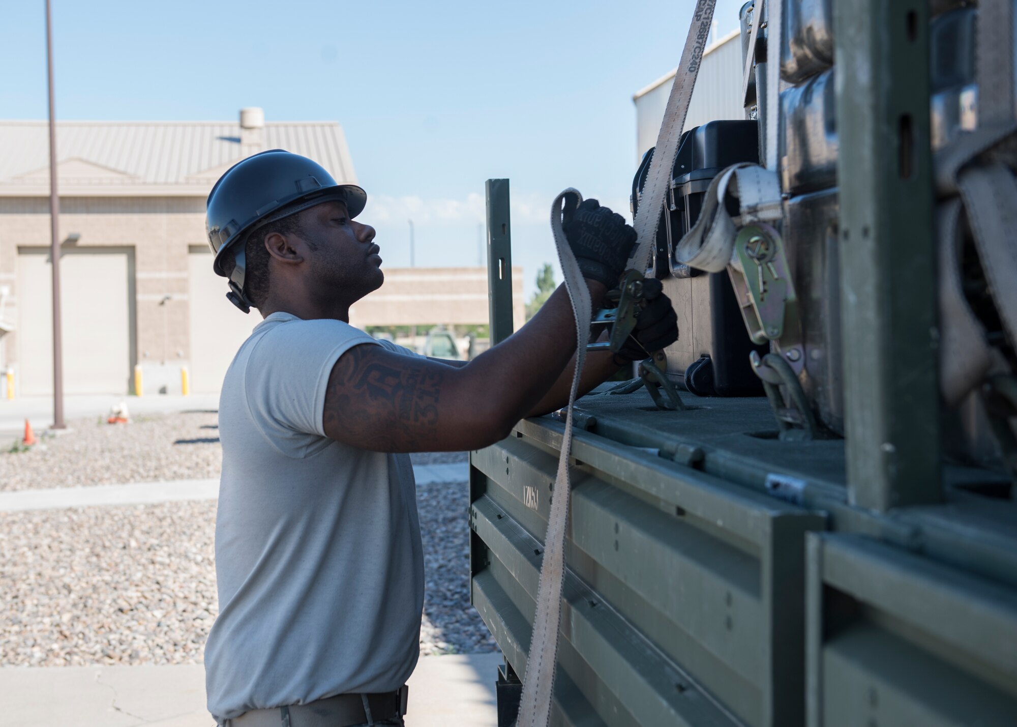 Staff Sgt. Kirt Alston, 726th Air Control Squadron, straps down supplies on a Medium Tactical Vehicle July 11, 2019, at Mountain Home Air Force Base, Idaho. The 726th ACS conducts inspections throughout the packing process to ensure mission supplies are properly loaded onto vehicles. (U.S. Air Force photo by Senior Airman Tyrell Hall)