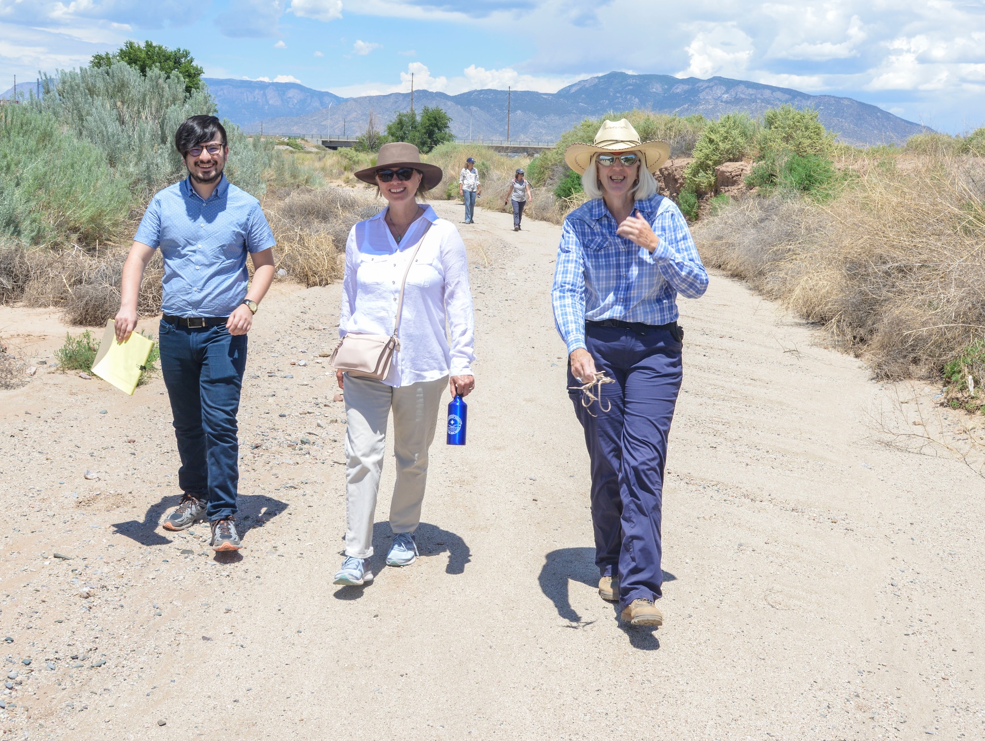 KIRTLAND AIR FORCE BASE, N.M. – (Left to Right) Staffer Joe Noriega and Bernalillo County Commissioner (District 5) Charlene Pyskoty, tour the Tijeras Arroyo here with Kirtland Bulk Fuels Facility Remediation expert Kate Lynnes July 16. Albuquerque Bernalillo County Water Utility Authority members Diane Agnew and Kate Mendoza (background) follow. (U.S. Air Force photo by Jim Fisher)