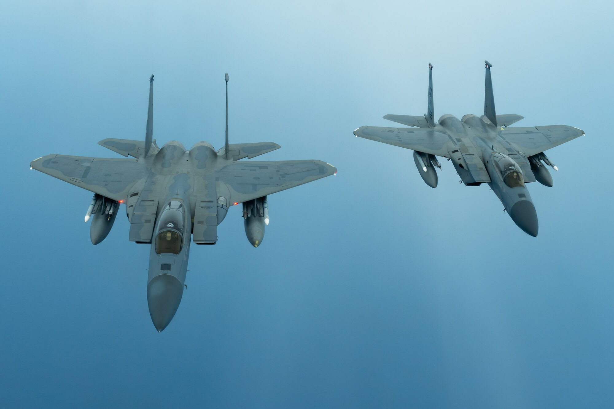 Two F-15C Eagles from the 44th Fighter Squadron fly during a training exercise July 10, 2019, out of Kadena Air Base, Japan. The Eagle can be armed with several combinations of different air-to-air weapons: AIM-120 AMRAAM advanced medium-range air-to-air missiles on its lower fuselage corners, AIM-9M/X Sidewinder or AIM-120 AMRAAM missiles on two pylons under the wings, and an internal 20 millimeter (0.79 in) M61 Vulcan Gatling gun in the right wing root. (U.S. Air Force photo by Airman 1st Class Matthew Seefeldt)