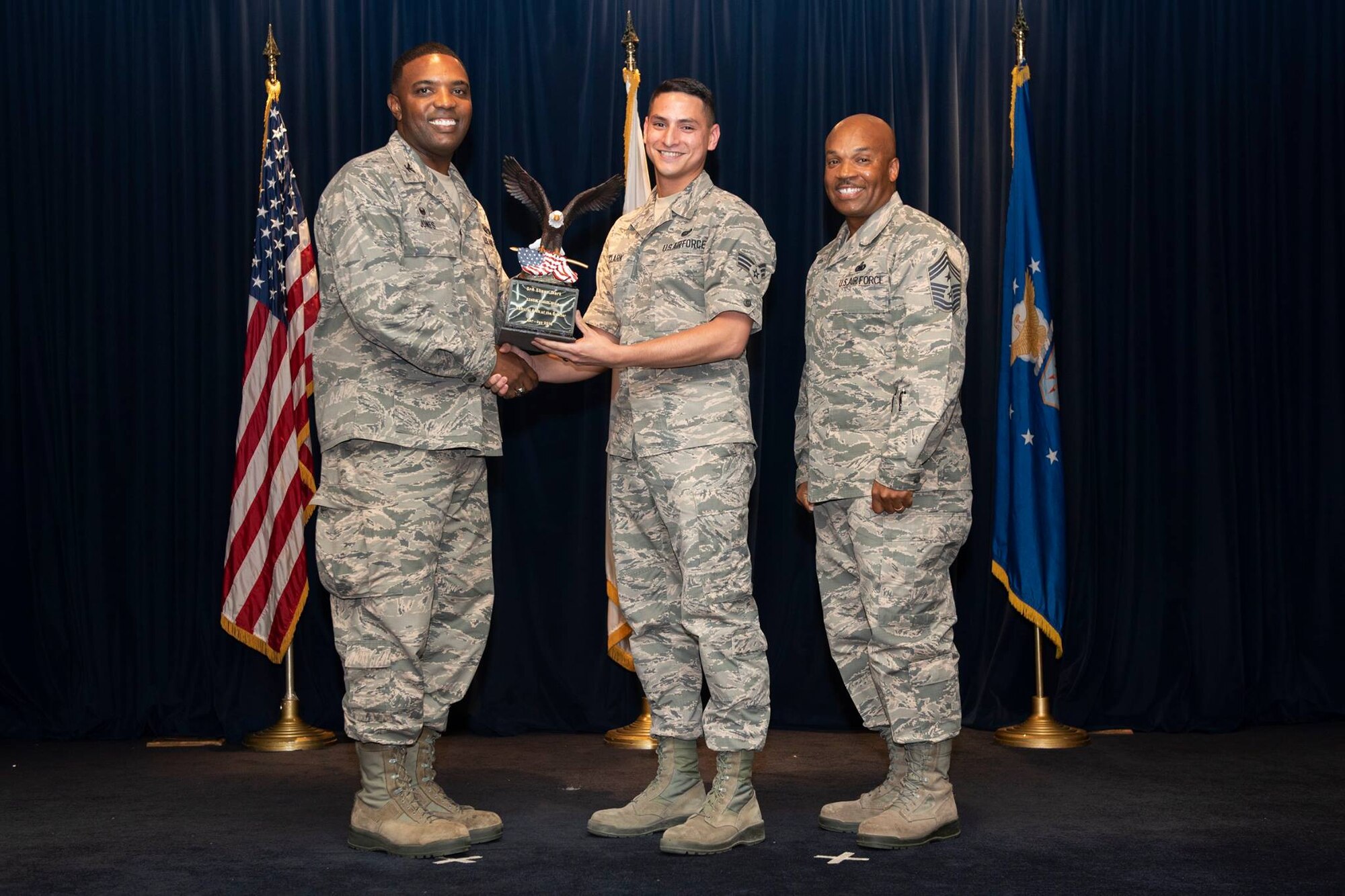 Senior Airman Shawn Clark, 374th Communications Squadron cyber operations technician,  is presented the Airman level 2nd Quarter 2018 award by Col. Otis C. Jones, 374th Airlift Wing commander, at Yokota Air Base, Japan, Aug. 2, 2018.
