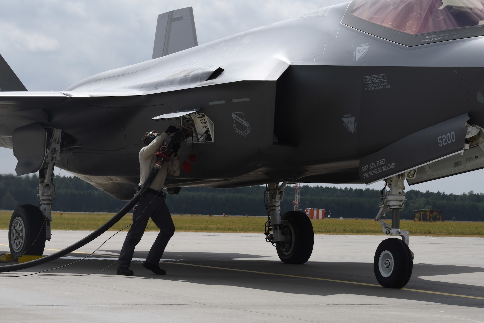 A U.S. Air Force member from the 336th Fighter Squadron, 4th Fighter Wing, Seymour Johnson Air Force Base, N.C., refuels a F-35A Lightning II fighter jet during Operation Rapid Forge on Powidz Air Base, Poland, July, 16, 2019. Operation Rapid Forge is intended to enhance interoperability with NATO allies to improve combined operational capabilities.